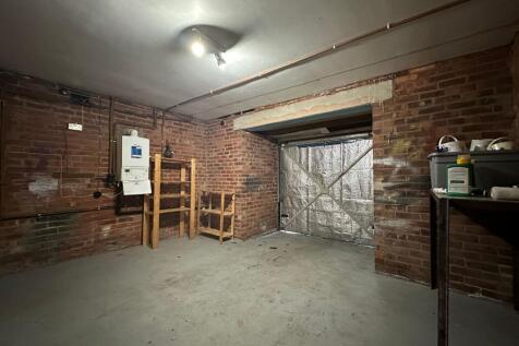 Secure brick-walled garage/storage room with sh...