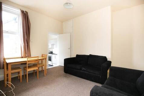 Bright, neutrally decorated living room with la...