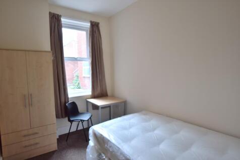 Compact, simply furnished bedroom with a single...