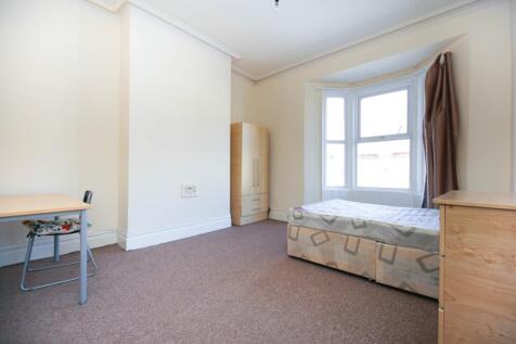 A bright and spacious double bedroom with large...