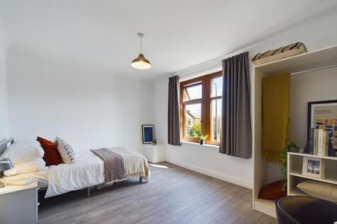 A bright and spacious double bedroom featuring ...