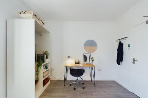 A bright and tidy double bedroom featuring a st...