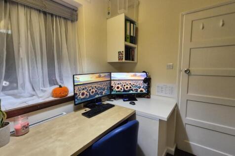 Bright, tidy study workspace with dual monitors...
