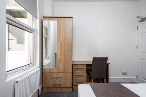 Bright, neatly presented bedroom with a large f...