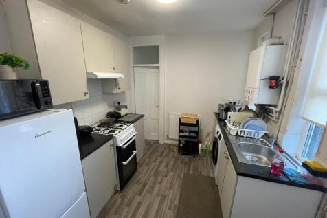 Bright galley-style kitchen with fitted cabinet...