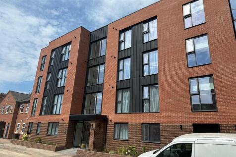 Modern brick apartment building with large wind...