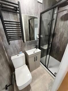Modern compact bathroom with a walk-in shower b...