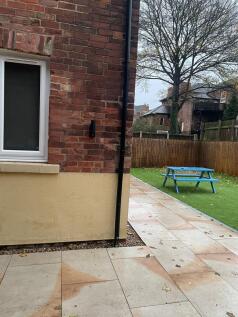 Well-maintained private rear garden with paved ...