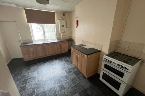A clean and functional kitchen with modern wood...