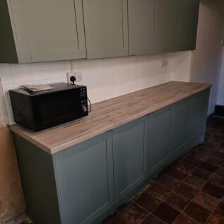 A compact kitchen area featuring clean, modern ...