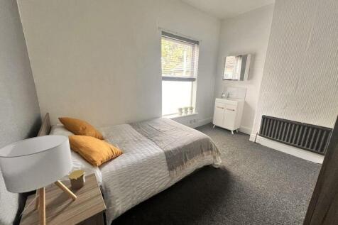 A bright and neatly arranged double bedroom fea...