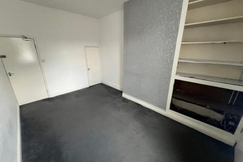 A simple double bedroom with neutral white wall...