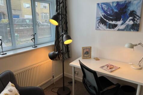 Bright, tidy study corner with a large window, ...