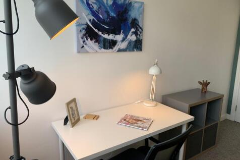 Bright, tidy study corner with a clean white de...