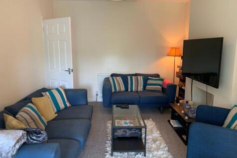 Bright, cosy living room with matching blue sof...