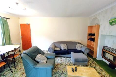 Bright, comfortable living room with a mix of s...