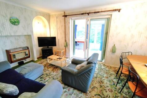 Bright, comfortable living room with seating, a...