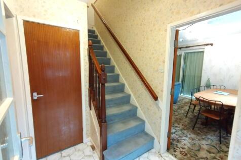 Welcoming entrance hallway with carpeted stairc...