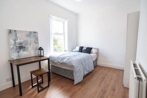 Bright, simply styled bedroom with a comfy doub...