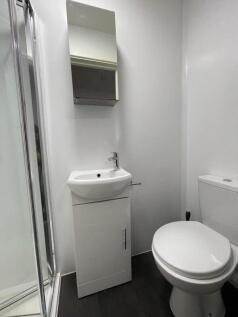 Compact, modern bathroom with a shower cubicle,...
