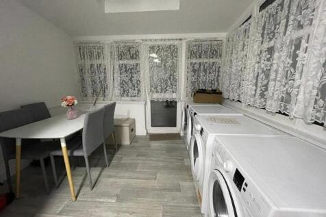 Bright, tidy communal room with large windows, ...