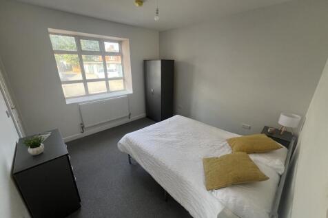 Bright, simply styled double bedroom with a lar...