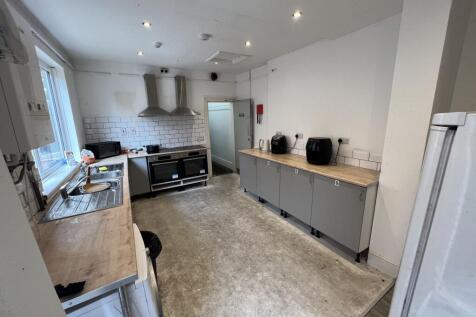 Spacious communal kitchen with long worktops, t...