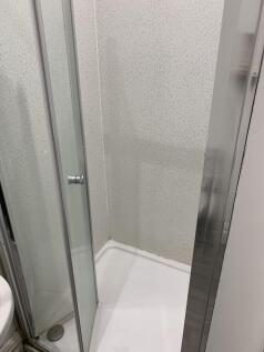 Compact bathroom shower cubicle with clear glas...