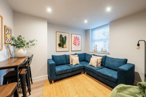 Bright, contemporary living room with a blue L-...