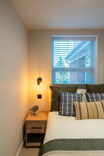 Well-styled bedroom corner with a comfy double ...