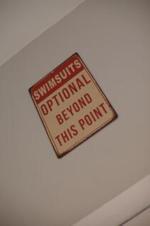 Decorative vintage sign mounted on a clean neut...