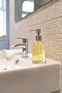 Stylish bathroom sink area with a modern chrome...
