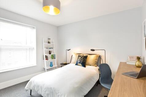 Bright, contemporary double bedroom with a comf...
