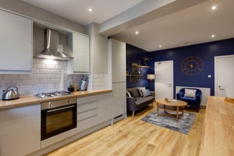 Stylish open-plan kitchen and living area with ...