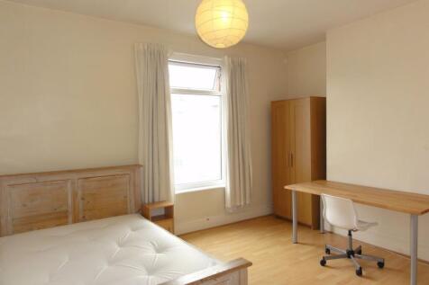 Bright, neutrally decorated double bedroom with...