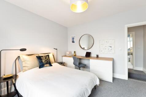 Bright, stylish bedroom with a comfortable doub...