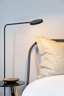 Stylish bedside with a modern metal bed frame, ...