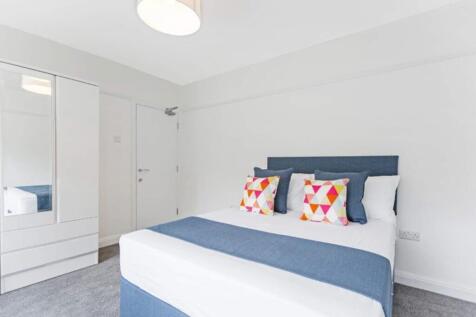 This inviting double bedroom features a comfort...