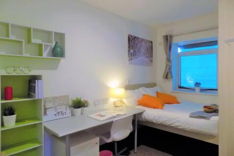 Bright, neatly arranged bedroom with a built-in...