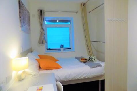 Bright, neatly presented bedroom with a comfort...