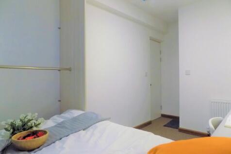 Bright, minimally-styled single bedroom with a ...