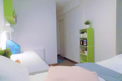 Bright, neatly styled bedroom with a comfortabl...