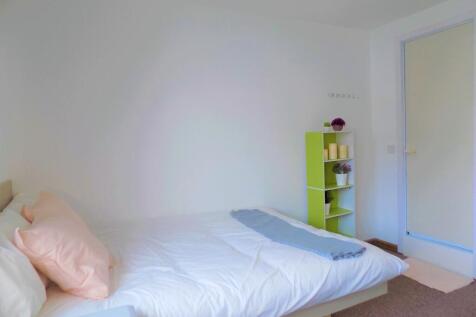 Bright, tidy bedroom with a made double bed, so...