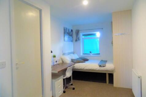 Bright, neatly arranged bedroom with a comforta...