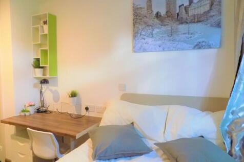 Bright, neatly-arranged bedroom with a comforta...