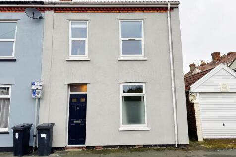 Street-facing terraced house with a modern grey...