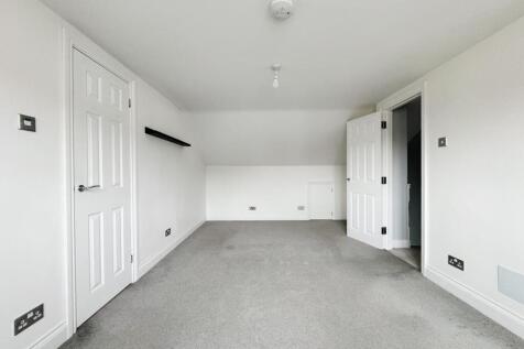 Bright, neutral double bedroom with fresh white...