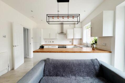 Bright, modern open-plan living area with a coz...