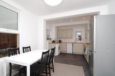 Bright open-plan kitchen and dining area with a...