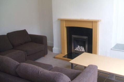 Bright, tidy living room with matching sofas, a...